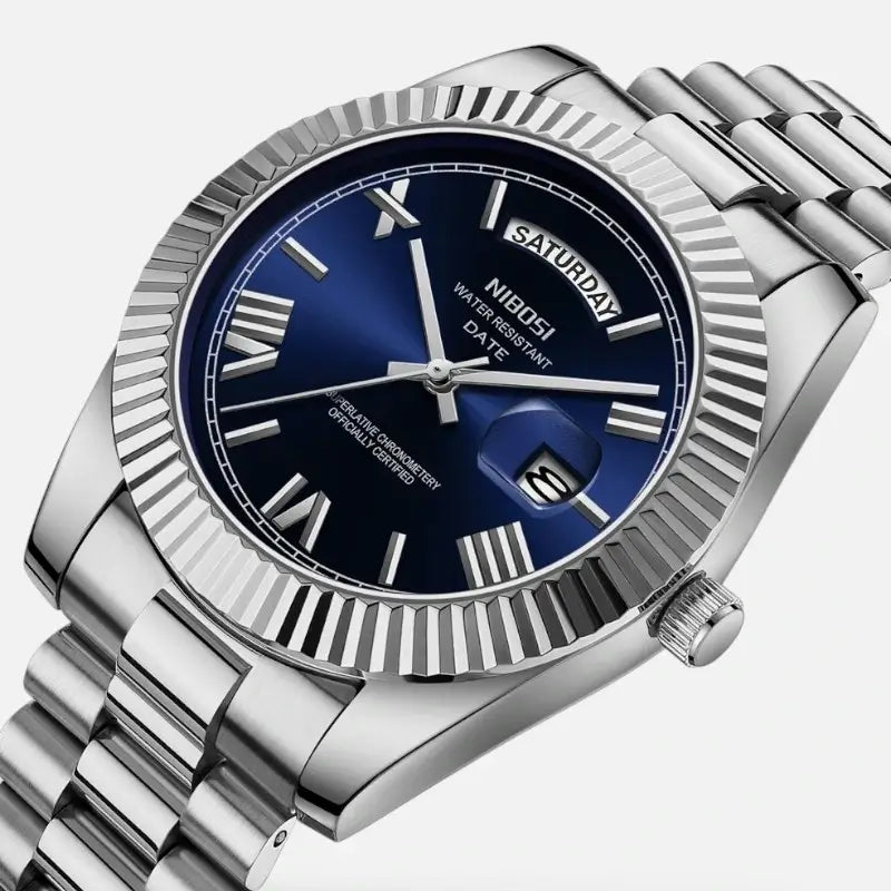 Close-up of VEXO Day Date watch with deep ocean blue dial, silver Roman numerals, fluted bezel, and stainless steel bracelet