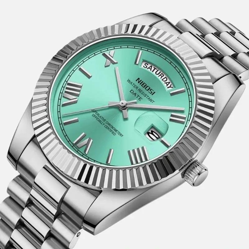 Close-up of VEXO Day Date watch with turquoise dial and silver stainless steel bracelet, fluted bezel, and calendar display