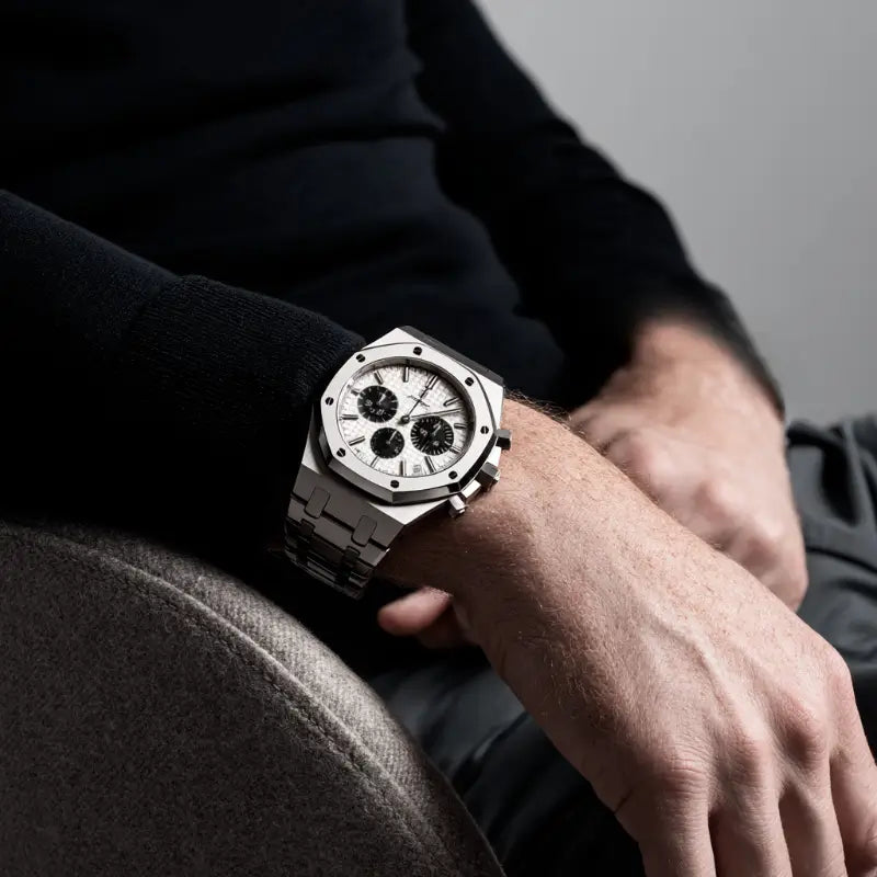 Man wearing the VEXO Kings Oak Chronograph Ice watch resting his arm on a chair, showcasing the watch’s bold presence and sophisticated design in a relaxed pose