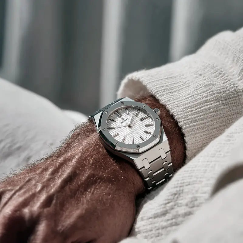 Close-up of a VEXO Kings Oak Ice watch worn on the wrist, featuring a white waffle-textured dial, stainless steel case, and brushed integrated bracelet in a soft-lit setting