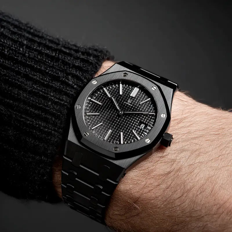 Wrist shot of the VEXO Kings Oak Obsidian featuring a bold black stainless steel case and bracelet with a dark waffle-textured dial and luminous markers