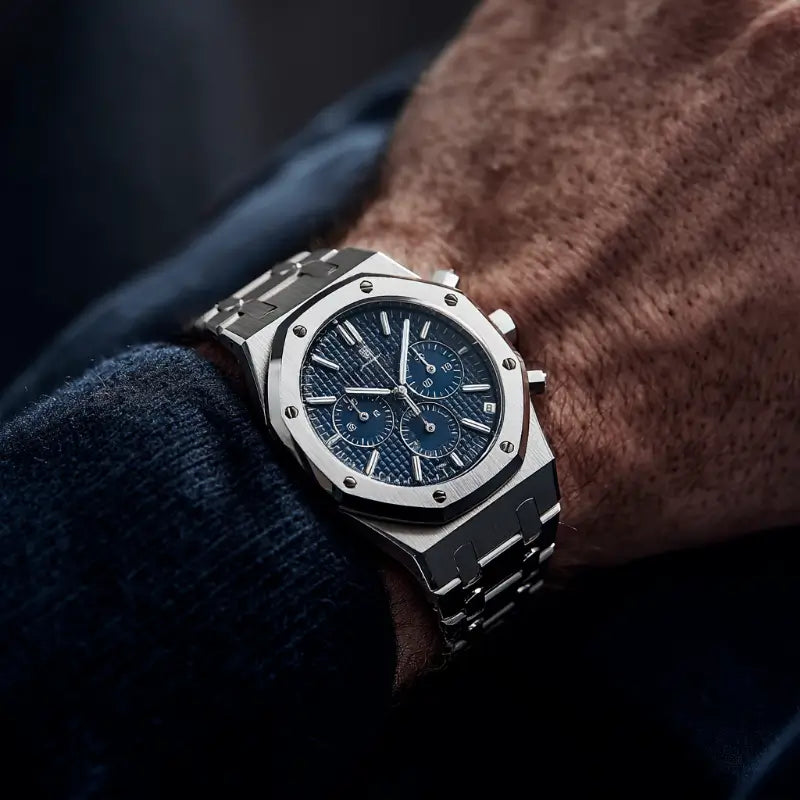 Close-up of VEXO Kings Oak Ocean watch with deep blue textured dial and chronograph features, worn with a navy sweater, emphasizing elegance and detail