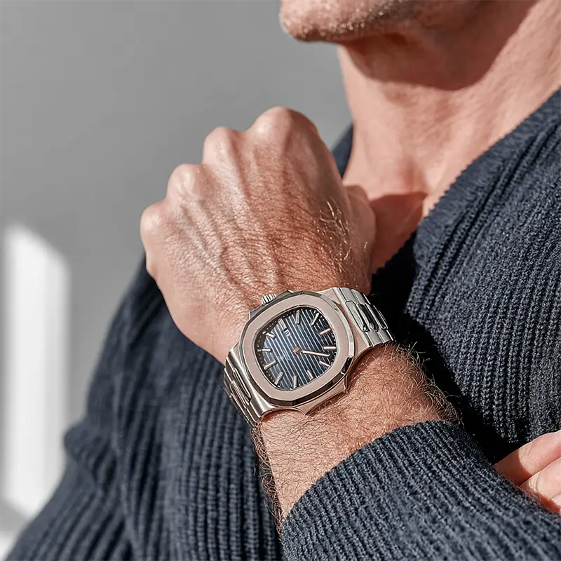 Vexo Nautilus Ocean watch with a deep blue dial and stainless steel bracelet worn outdoors, highlighted by natural sunlight and casual style